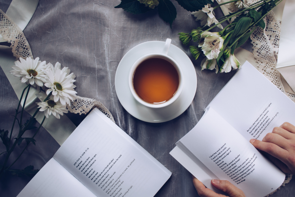 Best Books of 2020 Stock Photo - Books, Flowers, and coffee on a cloth covered table